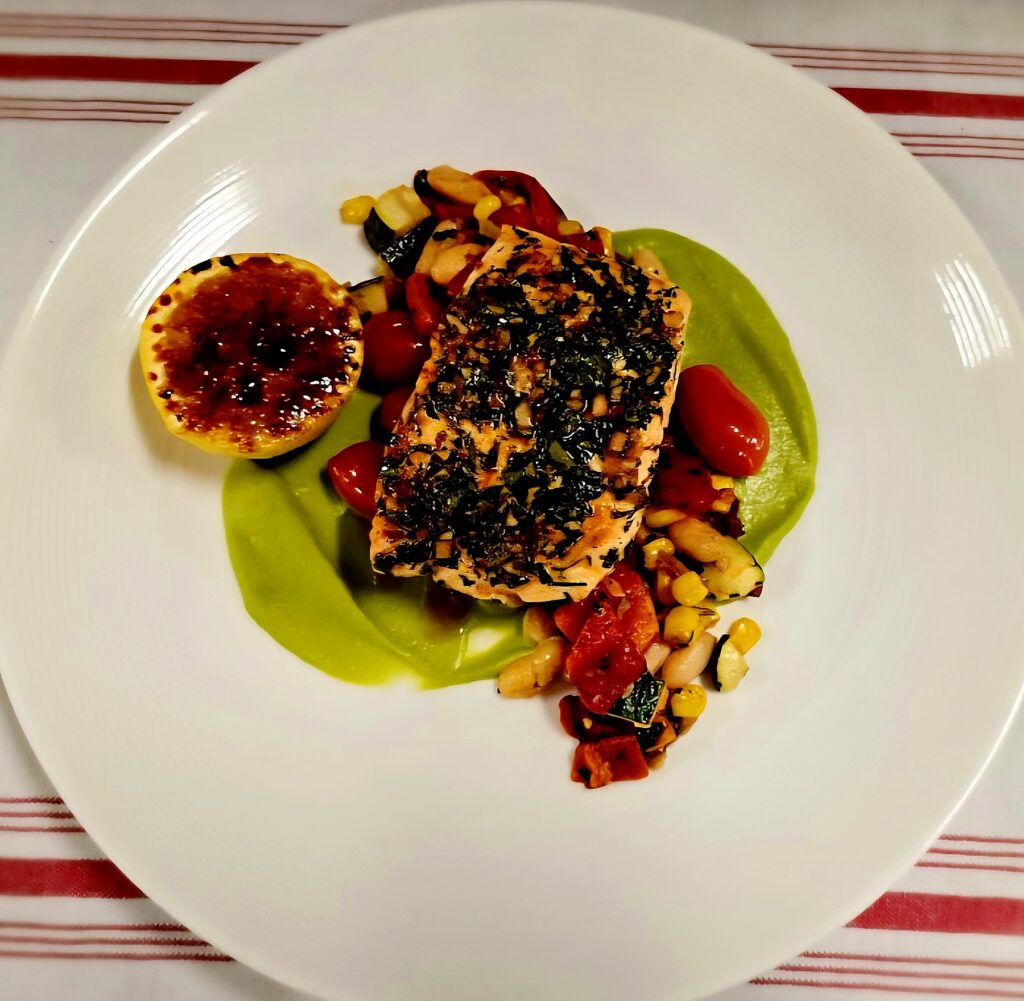 Chimichurri salmon on green chili sweet pea puree with bacon succotash and charred lemon, plated by a Denver private chef