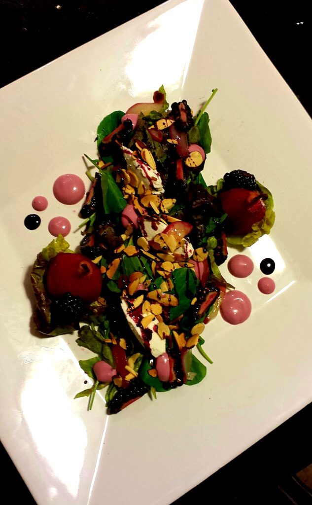 Poached pear and goat cheese salad with blackberries, toasted almonds and balsamic